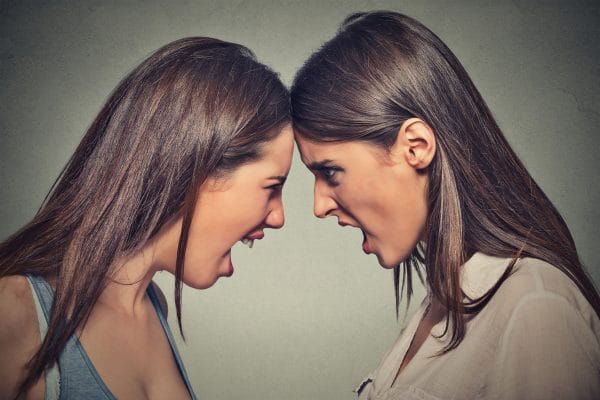 Two women fight. Angry women screaming looking at each other